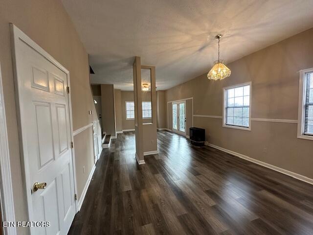 unfurnished living room with dark hardwood / wood-style floors