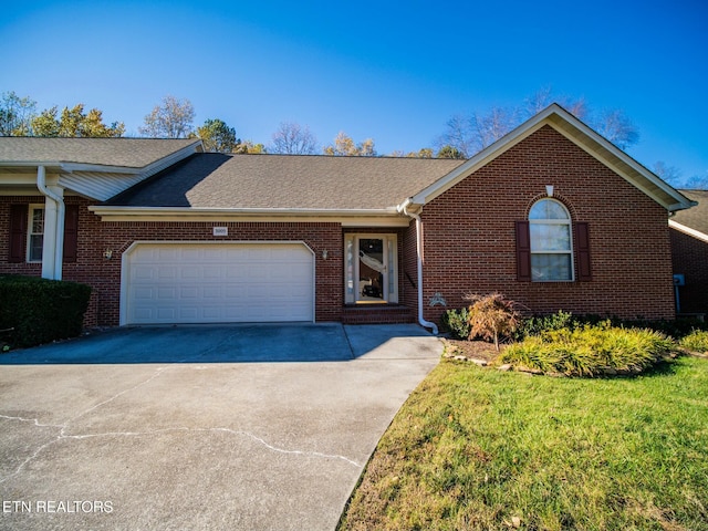 single story home with a garage and a front yard