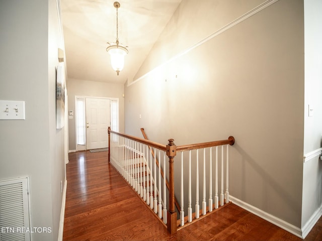 hall featuring lofted ceiling and dark hardwood / wood-style flooring