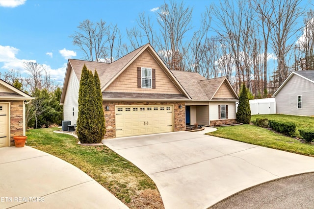 craftsman inspired home featuring a garage, central AC unit, and a front lawn