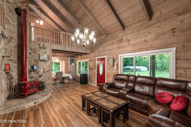 living room with hardwood / wood-style flooring, wood ceiling, beam ceiling, and a wood stove