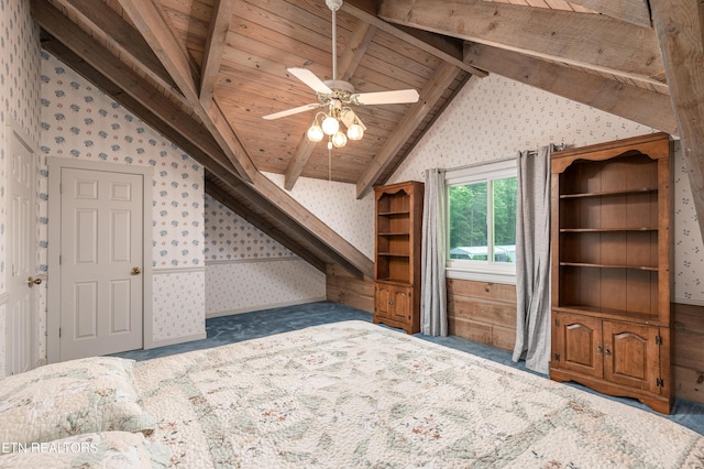 unfurnished bedroom featuring wood ceiling, ceiling fan, dark carpet, and vaulted ceiling with beams