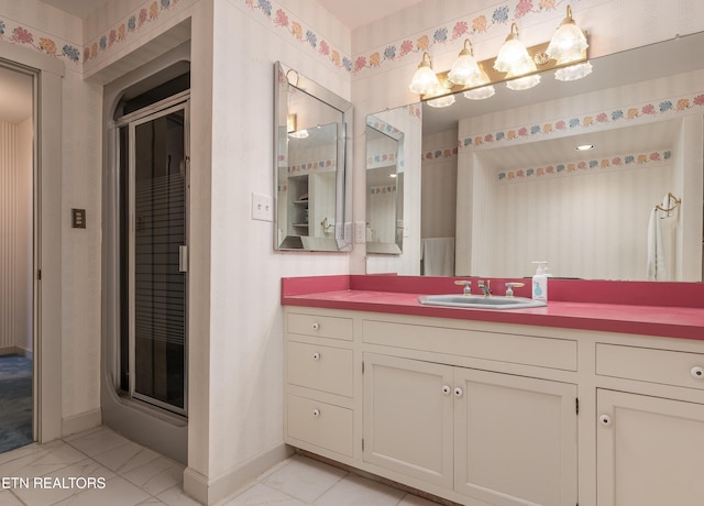 bathroom with vanity and a shower with shower door