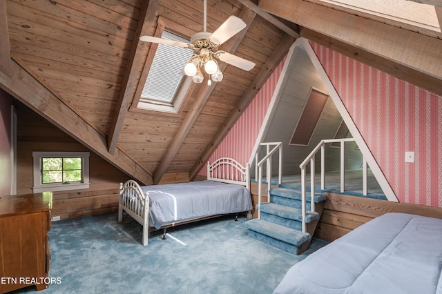 bedroom featuring dark carpet, wooden walls, wooden ceiling, and vaulted ceiling with skylight