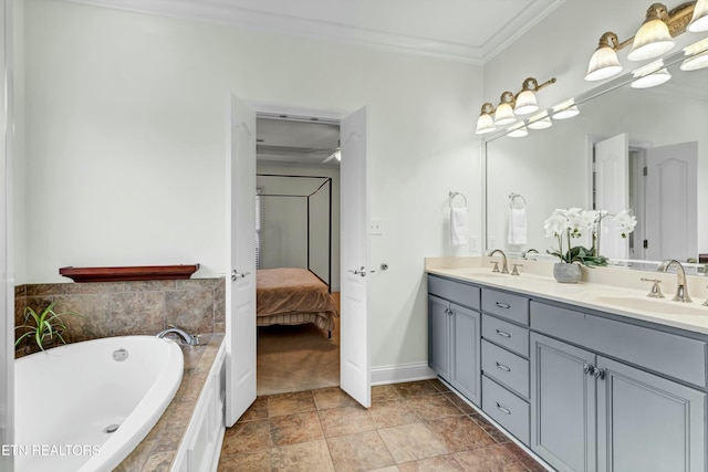 bathroom with crown molding, vanity, and tiled tub