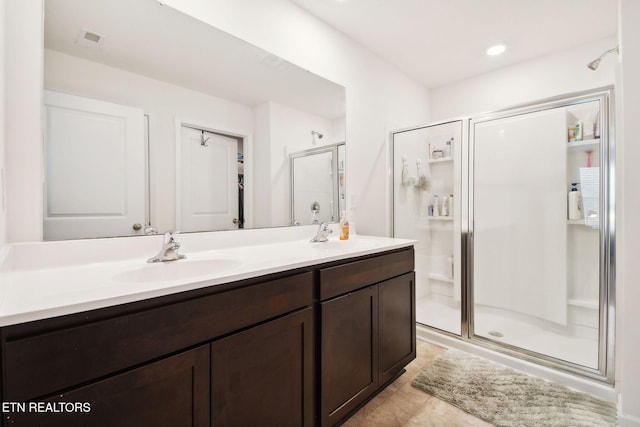 bathroom featuring an enclosed shower and vanity