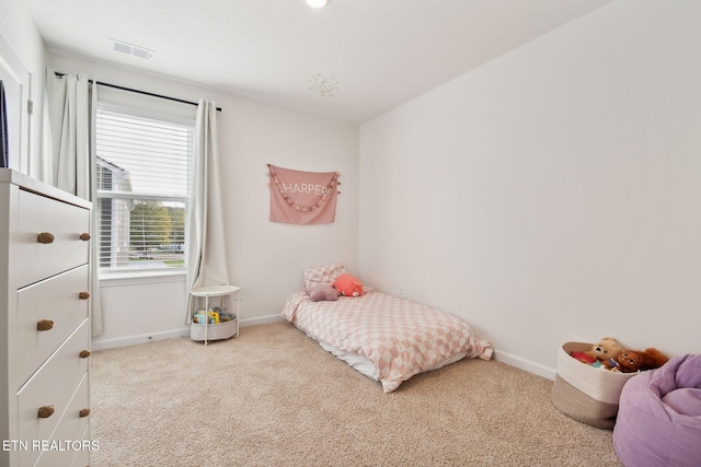 bedroom with light colored carpet