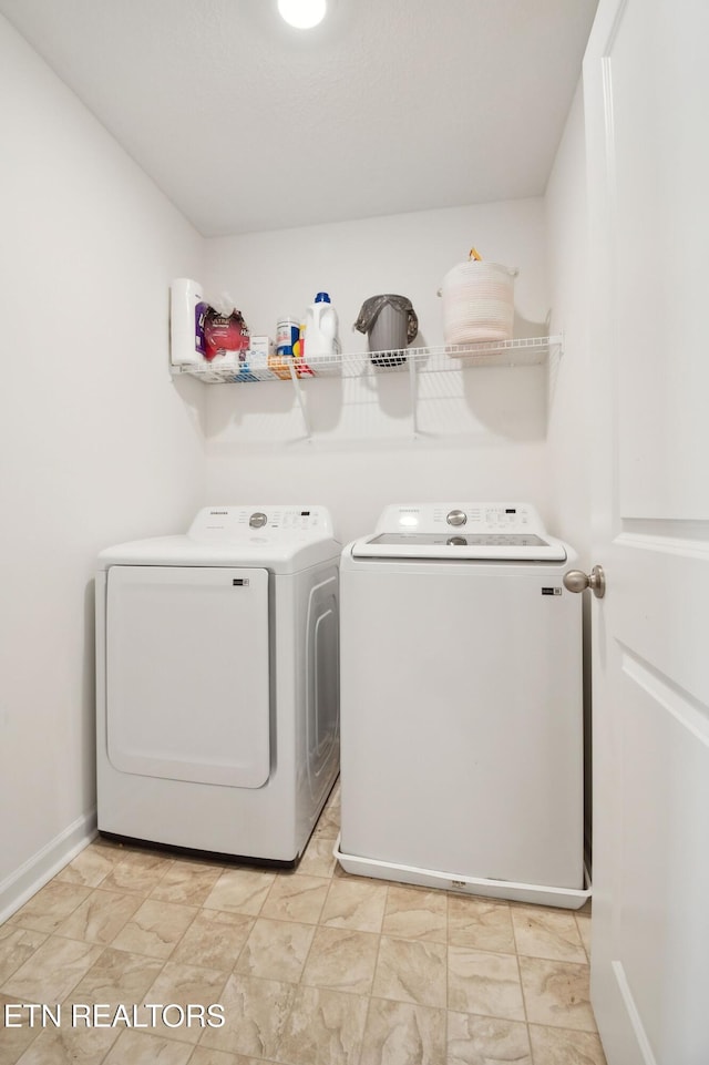 clothes washing area with washing machine and dryer