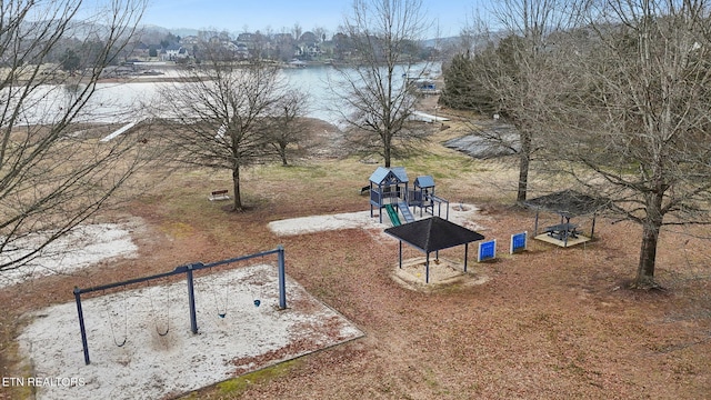 exterior space with a playground and a water view