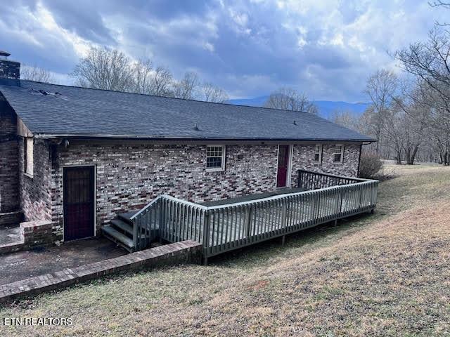 back of house featuring a yard and a deck