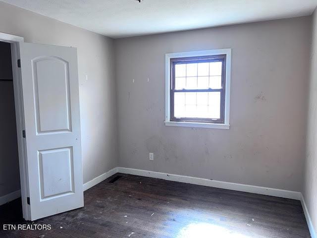 empty room with dark hardwood / wood-style floors