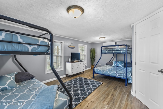 bedroom with dark hardwood / wood-style flooring and a textured ceiling