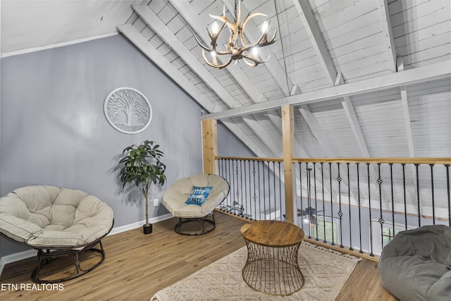 sitting room featuring an inviting chandelier, hardwood / wood-style floors, lofted ceiling with beams, and wooden ceiling