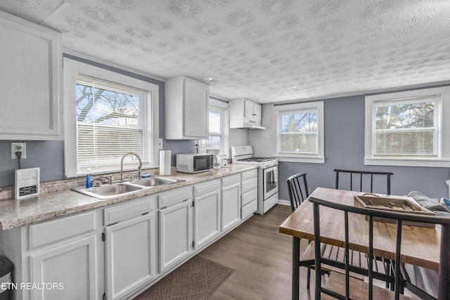 kitchen featuring white cabinetry, sink, dark hardwood / wood-style flooring, white range with gas stovetop, and a textured ceiling