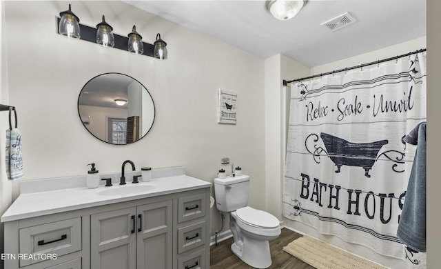 full bathroom with vanity, wood-type flooring, shower / bath combination with curtain, and toilet