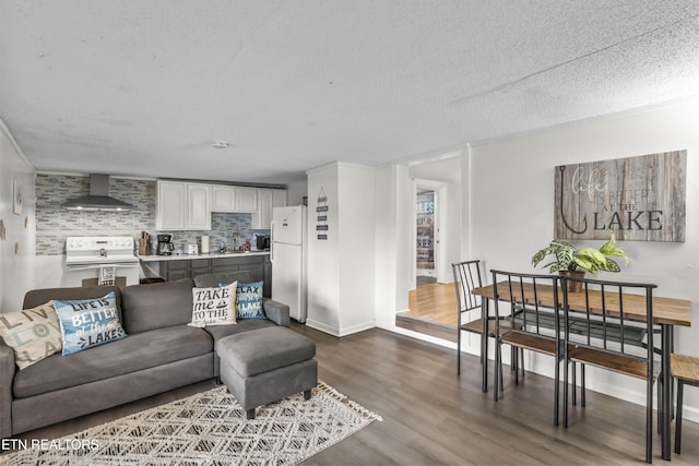 living room featuring wood-type flooring and a textured ceiling