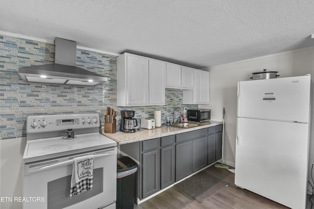 kitchen featuring sink, gray cabinets, white appliances, wall chimney range hood, and white cabinets