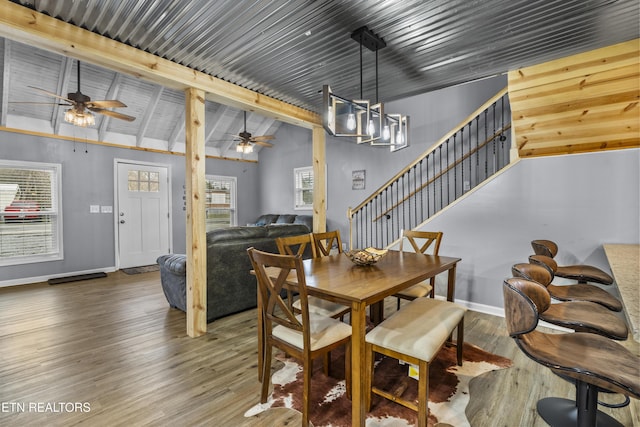 dining room with lofted ceiling with beams, hardwood / wood-style floors, and ceiling fan