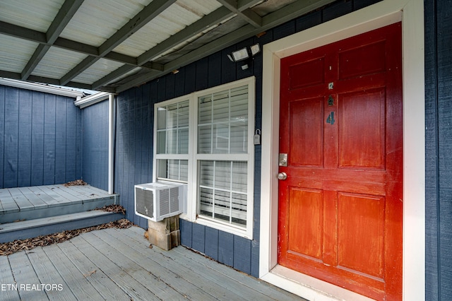 property entrance with cooling unit and a porch