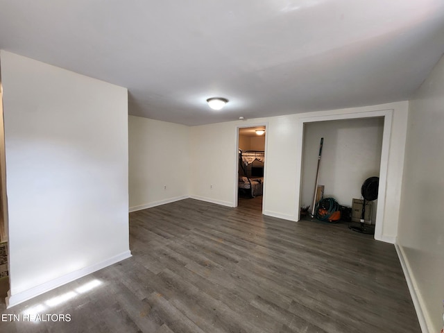 empty room with dark hardwood / wood-style floors