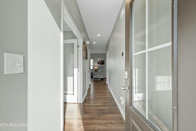 corridor with dark hardwood / wood-style floors