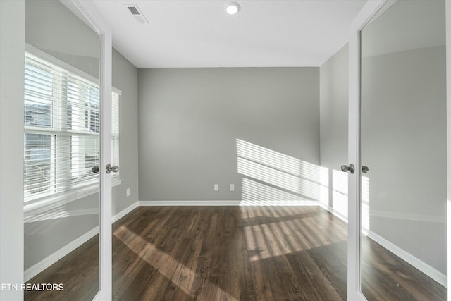 unfurnished room with french doors and dark hardwood / wood-style flooring