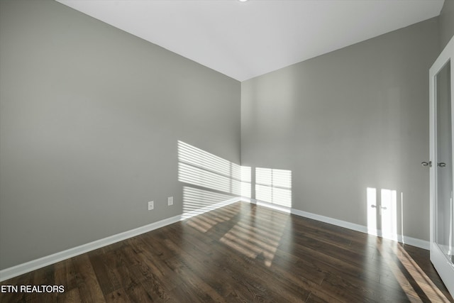 unfurnished room with dark hardwood / wood-style floors