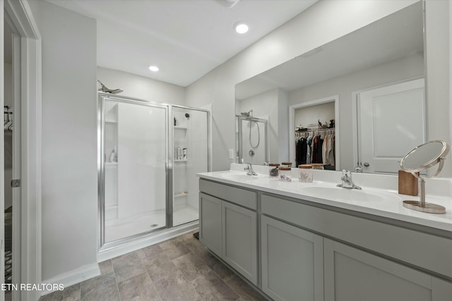 bathroom with an enclosed shower and vanity