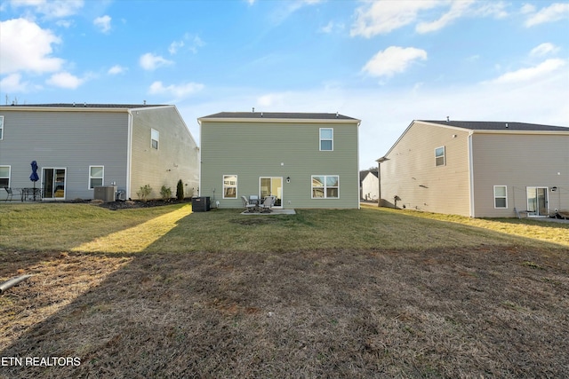 rear view of house featuring a patio, cooling unit, and a lawn