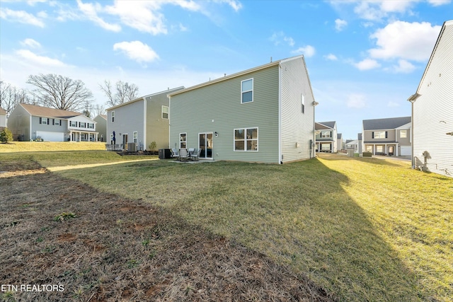 rear view of house featuring a yard and a patio