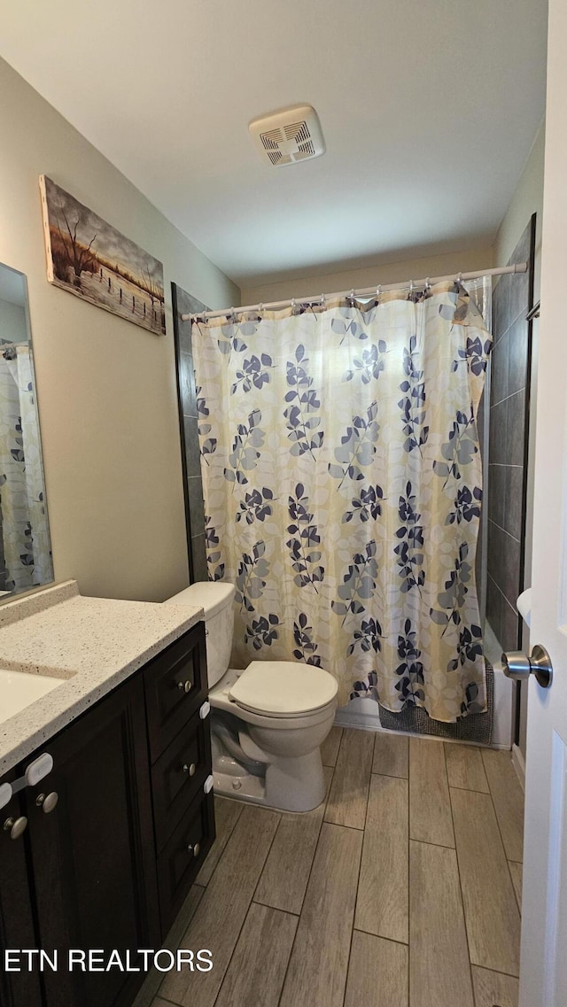 full bathroom with vanity, toilet, and shower / bath combo