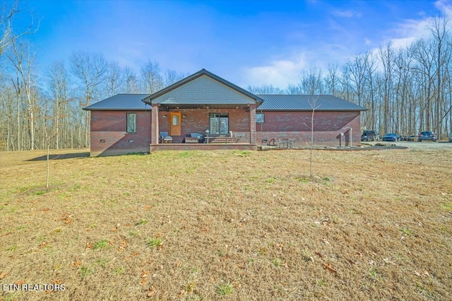 rear view of property with a lawn and a porch