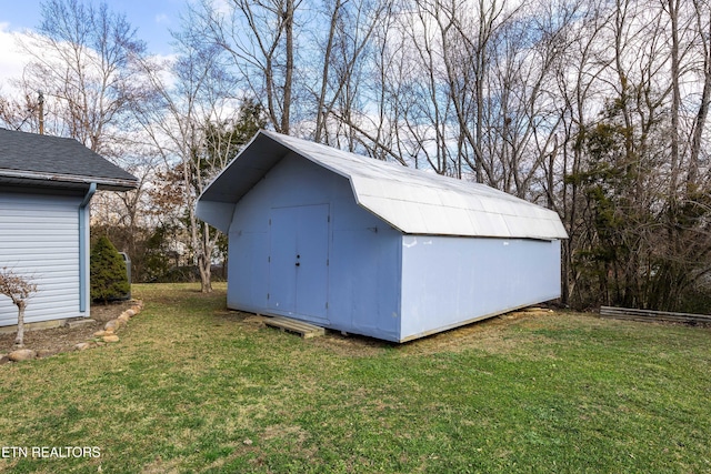 view of outbuilding with a lawn