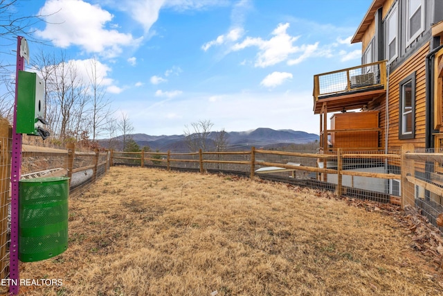 view of yard with a mountain view and a rural view