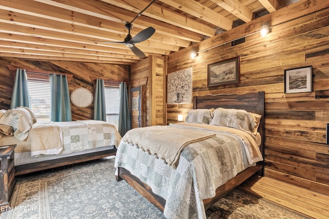 bedroom featuring wood walls and beamed ceiling