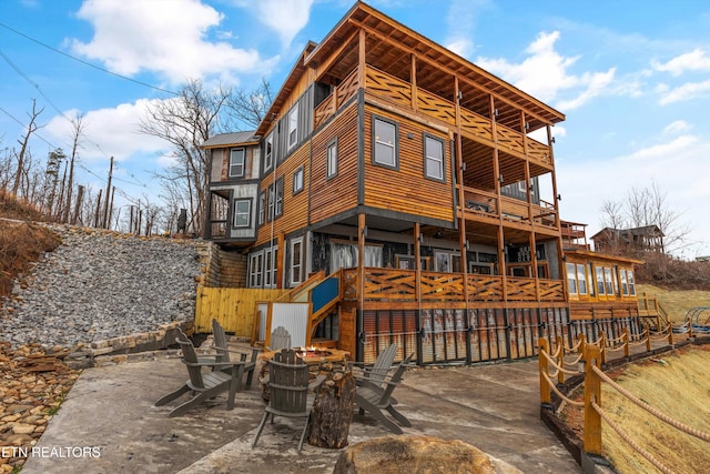 rear view of house featuring metal roof, a patio area, and a balcony