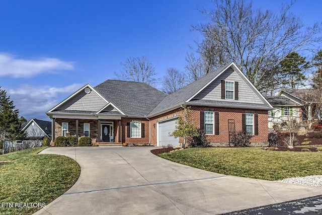 view of front of house featuring a garage, covered porch, and a front lawn