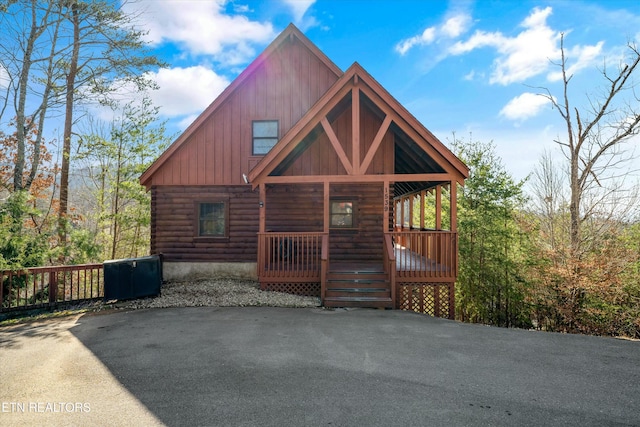 log-style house featuring a porch