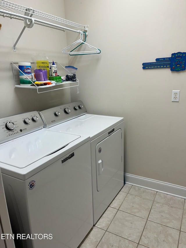 clothes washing area featuring separate washer and dryer and light tile patterned floors