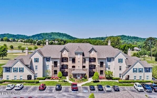 exterior space with a residential view, a mountain view, and uncovered parking