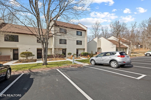 uncovered parking lot with a residential view