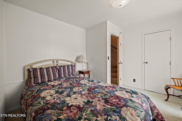 carpeted bedroom featuring a textured ceiling