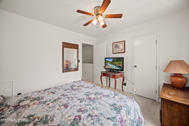 bedroom featuring a ceiling fan and light colored carpet