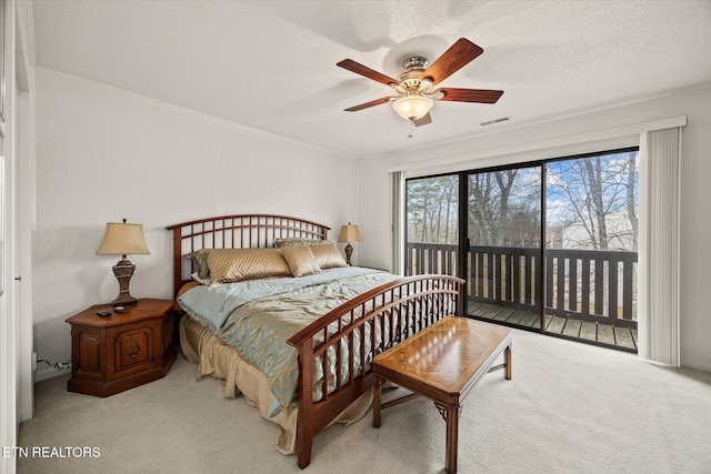 bedroom featuring a textured ceiling, ceiling fan, light colored carpet, visible vents, and access to outside