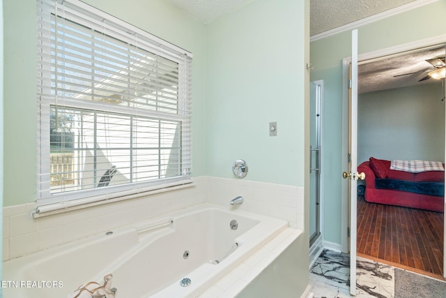 bathroom with shower with separate bathtub and a textured ceiling