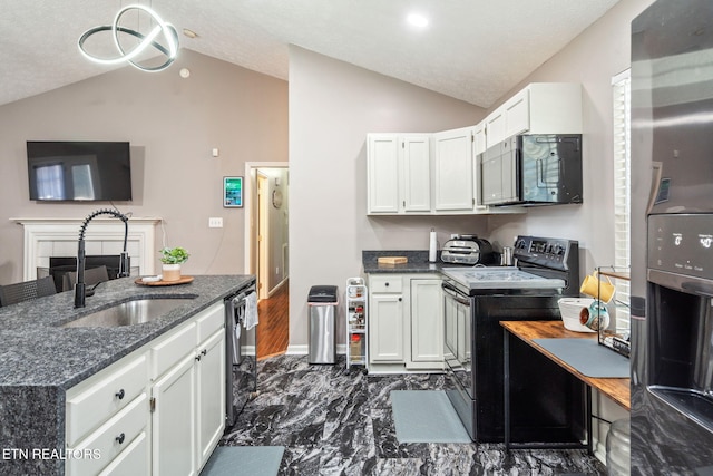 kitchen with white cabinetry, sink, lofted ceiling, and appliances with stainless steel finishes