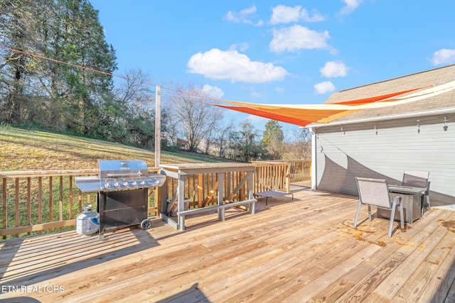 wooden deck with a grill