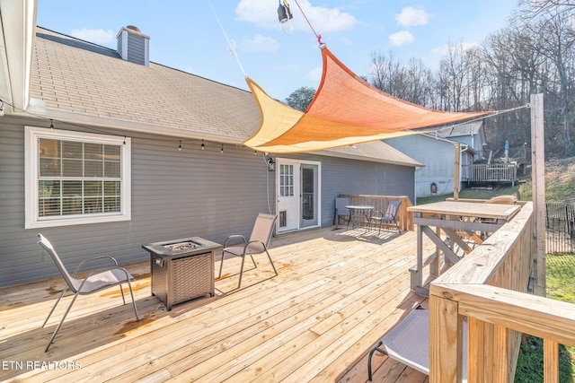 wooden deck with a fire pit