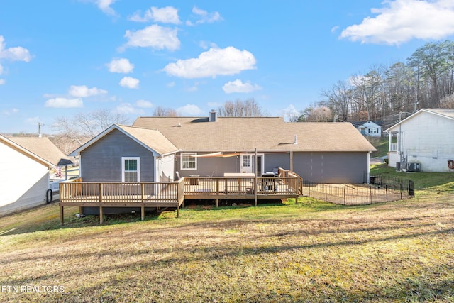 rear view of house featuring a wooden deck, a yard, and cooling unit