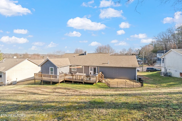 back of house with central AC, a lawn, and a deck